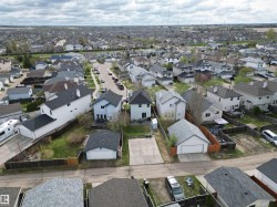 Aerial perspective of a residential neighborhood featuring detached homes with varying architectural styles - 