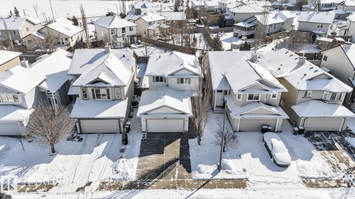 Suburban neighborhood featuring multiple detached homes with snow-covered pitched roofs and attached garages - 421 84 Street, Edmonton, AB - Outdoor With Facade