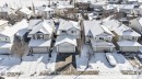 Suburban neighborhood featuring multiple detached homes with snow-covered pitched roofs and attached garages - 421 84 Street, Edmonton, AB  - Outdoor With Facade 