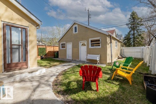 Manicured lawn with a concrete pathway and white picket fence - 10939 96 Street, Edmonton, AB - Outdoor