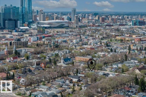 Aerial perspective showcasing a residential area with a prominent city skyline in the background - 10939 96 Street, Edmonton, AB - Outdoor With View