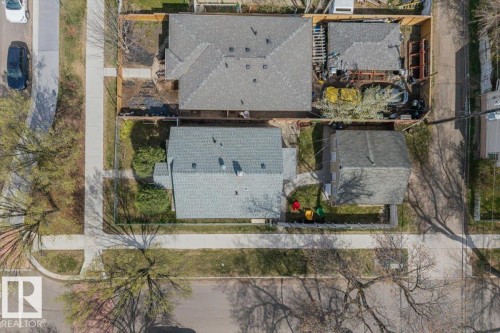 Property features a shingle roof, a detached garage, and a fenced perimeter - 10939 96 Street, Edmonton, AB - Outdoor