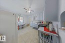Kitchen featuring light-toned floor tiling, painted cabinetry with a tile backsplash, and a built-in oven - 10939 96 Street, Edmonton, AB  - Indoor Photo Showing Other Room 