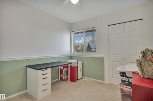 Room featuring neutral carpeting, a dual-tone wall finish with a chair rail, and a window with blinds - 102 4415 South Park Drive, Leduc, AB - Indoor