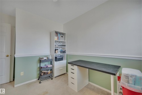 Neutral wall tones featuring a chair rail molding over a muted green lower wall - 102 4415 South Park Drive, Leduc, AB - Indoor