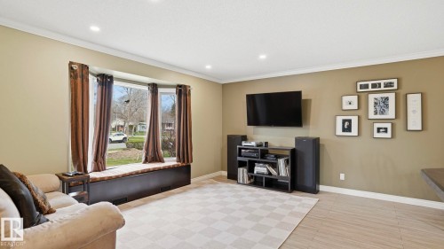 Bay window with integrated window seat, crown molding, recessed lighting, and wood-finish flooring - 27 Addison Crescent, St. Albert, AB - Indoor