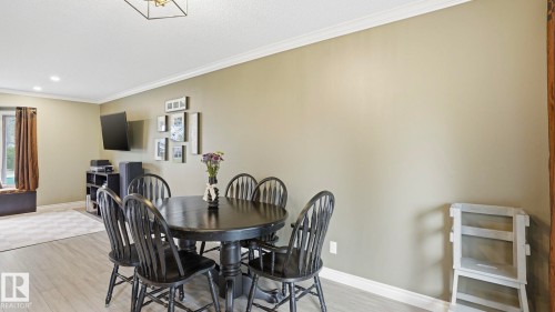 Spacious room featuring light-toned wood-finish flooring, recessed lighting, and crown molding - 27 Addison Crescent, St. Albert, AB - Indoor Photo Showing Dining Room