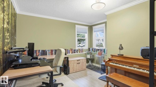 Dedicated room with wood-finish flooring, two windows with blinds, and crown molding - 27 Addison Crescent, St. Albert, AB - Indoor Photo Showing Office