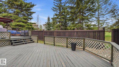 Multi-level wood deck featuring lattice railing, stairs, and a privacy fence - 27 Addison Crescent, St. Albert, AB - Outdoor With Deck Patio Veranda