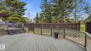 Multi-level wood deck featuring lattice railing, stairs, and a privacy fence - 27 Addison Crescent, St. Albert, AB  - Outdoor With Deck Patio Veranda 