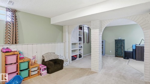 Lower level room featuring carpet flooring, painted wainscoting, and recessed window - 27 Addison Crescent, St. Albert, AB - Indoor