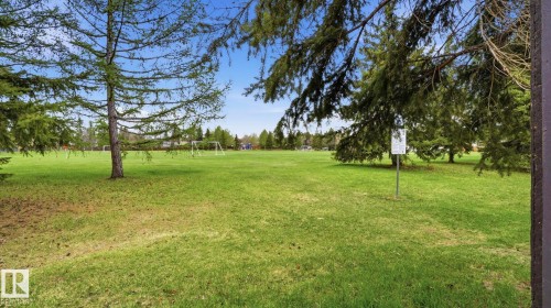 Expansive green space featuring large mature trees and distant sports goals - 27 Addison Crescent, St. Albert, AB - Outdoor With View