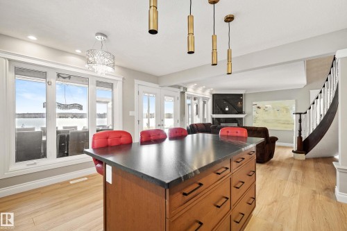 Central kitchen island with a dark countertop and wood-finish cabinetry - 104 Bayview Drive, Rural Parkland County, AB - Indoor