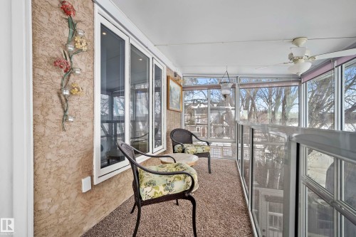 Enclosed porch featuring large windows, textured wall finish, and a ceiling fan - 104 Bayview Drive, Rural Parkland County, AB - Indoor Photo Showing Other Room