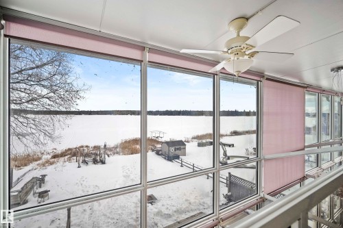 Expansive window wall offering waterfront exposure - 104 Bayview Drive, Rural Parkland County, AB - Indoor Photo Showing Other Room