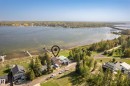 Waterfront property featuring a private dock and direct lake access - 104 Bayview Drive, Rural Parkland County, AB  - Outdoor With Body Of Water With View 