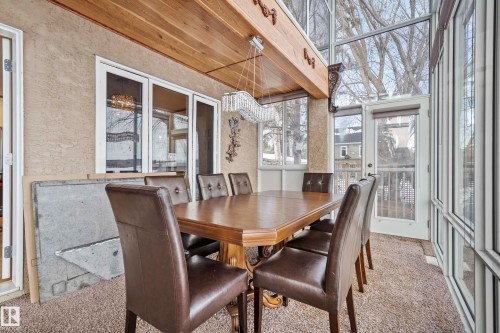 Enclosed sunroom featuring a textured wall, wood-finish ceiling, and expansive windows - 104 Bayview Drive, Rural Parkland County, AB -  Photo Showing Dining Room