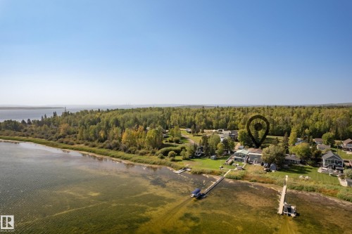 Waterfront property featuring extensive shoreline, private dock, and surrounding mature trees - 104 Bayview Drive, Rural Parkland County, AB - Outdoor With Body Of Water With View