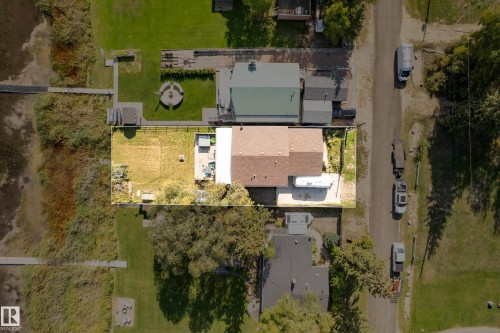 Single-story residence featuring a brown shingle roof and a light-colored patio area - 104 Bayview Drive, Rural Parkland County, AB 