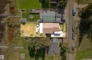 Single-story residence featuring a brown shingle roof and a light-colored patio area - 104 Bayview Drive, Rural Parkland County, AB  - Outdoor With View 