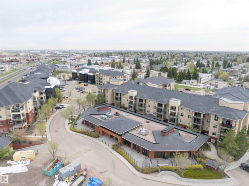 Multi-story residential buildings with private balconies and a commercial building with brick-clad exterior - 135 7825 71 Street, Edmonton, AB - Outdoor With View