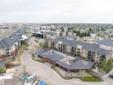 Multi-story residential buildings with private balconies and a commercial building with brick-clad exterior - 135 7825 71 Street, Edmonton, AB  - Outdoor With View 