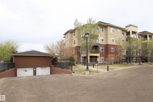 Multi-story building featuring tan and brown exterior siding with multiple balconies - 135 7825 71 Street, Edmonton, AB - Outdoor