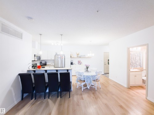 Open-concept living area with light wood-finish flooring - 135 7825 71 Street, Edmonton, AB - Indoor Photo Showing Dining Room