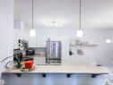 Kitchen featuring white cabinetry, stainless steel appliances, a double basin sink, and a speckled countertop - 135 7825 71 Street, Edmonton, AB  - Indoor Photo Showing Kitchen With Upgraded Kitchen 