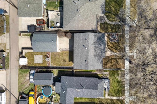 Single-story residence with a gray shingle roof, accompanied by a detached garage - 12016 51 Street, Edmonton, AB - Outdoor With Deck Patio Veranda