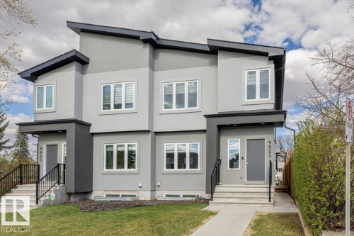 Modern duplex exterior featuring a two-tone gray stucco facade - 9933 79 Street, Edmonton, AB - Outdoor With Facade