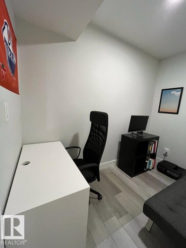Dedicated room featuring light wood-finish flooring, white walls, and a built-in recessed ceiling - 9933 79 Street, Edmonton, AB - Indoor Photo Showing Office