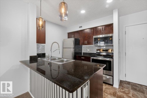 117 12035 22 Av, Edmonton, AB - Indoor Photo Showing Kitchen With Stainless Steel Kitchen With Double Sink With Upgraded Kitchen