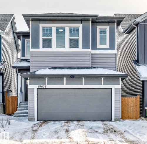 This property presents a modern exterior with varied siding textures and a prominent attached garage - 19635 29 Avenue, Edmonton, AB - Outdoor