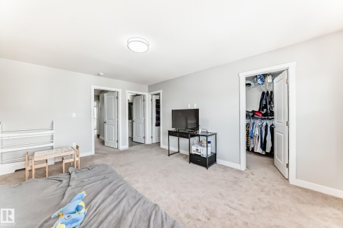 Bedroom featuring light-colored walls, carpeted flooring, and a flush mount ceiling light - 19635 29 Avenue, Edmonton, AB - Indoor