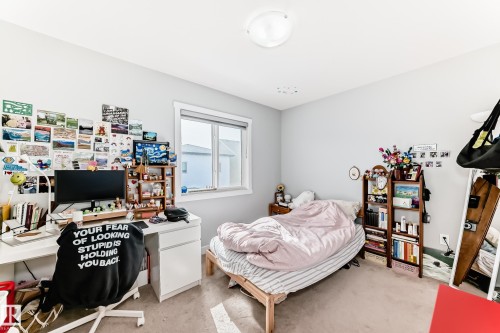 This room features neutral-toned walls, a window providing natural light, and a ceiling-mounted light fixture - 19635 29 Avenue, Edmonton, AB - Indoor Photo Showing Other Room