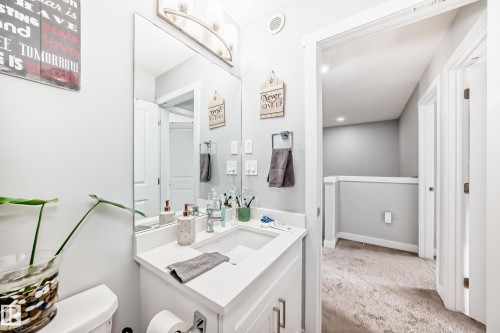 The property features a bathroom with a white vanity and countertop, a rectangular sink, and a large mirror - 19635 29 Avenue, Edmonton, AB - Indoor Photo Showing Bathroom