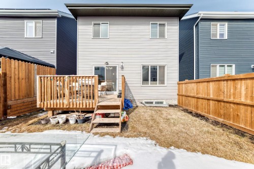 The property features a private backyard with a wooden deck, a sliding glass door leading into the interior, and a wooden privacy fence - 19635 29 Avenue, Edmonton, AB - Outdoor With Exterior