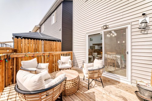 The property features a wooden deck with a privacy fence and a sliding glass door providing access to the interior - 19635 29 Avenue, Edmonton, AB - Outdoor With Deck Patio Veranda With Exterior
