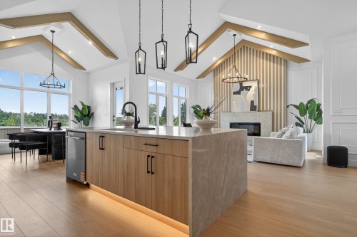 Spacious kitchen island with a waterfall countertop, integrated sink, and modern cabinetry - 711 166 Avenue, Edmonton, AB - Indoor