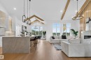Open-concept interior featuring light wood-finish flooring and a vaulted ceiling with exposed wood beams - 711 166 Avenue, Edmonton, AB  - Indoor Photo Showing Living Room 