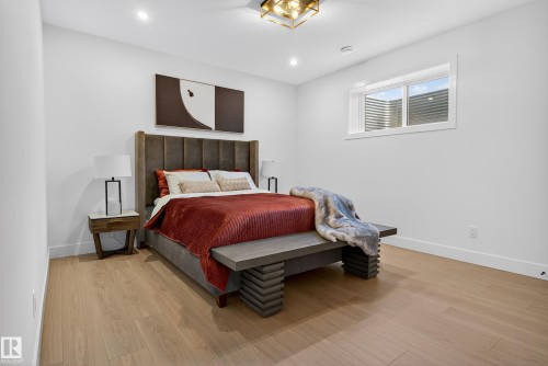 Bedroom featuring wood-finish flooring, recessed lighting, and a square window - 711 166 Avenue, Edmonton, AB - Indoor Photo Showing Bedroom