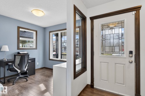 Entryway featuring a decorative glass panel door and rich wood-finish trim - 108 Hewitt Circle, Spruce Grove, AB - Indoor
