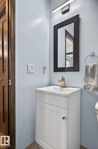 Compact bathroom vanity featuring a white cabinet, integrated sink, and gold-tone faucet - 108 Hewitt Circle, Spruce Grove, AB - Indoor Photo Showing Bathroom