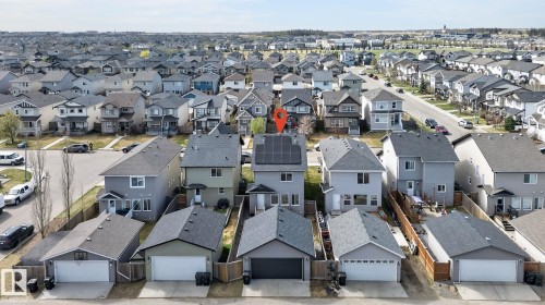 Grey two-story residence featuring a dark shingle roof with solar panels - 108 Hewitt Circle, Spruce Grove, AB - Outdoor
