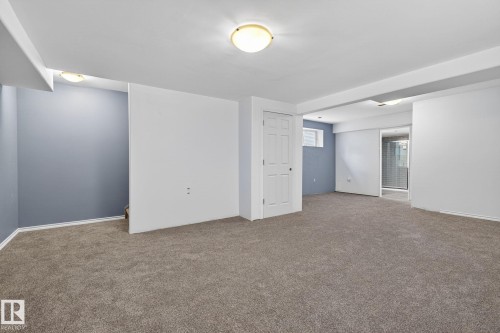 Spacious open area featuring neutral carpeting, white trim, and recessed lighting - 108 Hewitt Circle, Spruce Grove, AB - Indoor Photo Showing Other Room