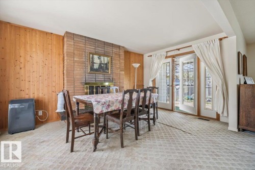Dining area featuring a brick fireplace - 9732 64 Street, Edmonton, AB - Indoor Photo Showing Dining Room