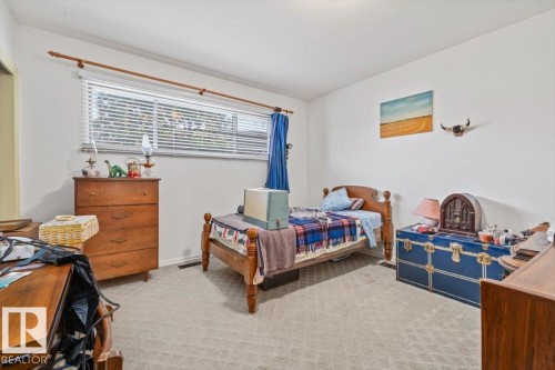 White walls with a light-toned carpet flooring - 9732 64 Street, Edmonton, AB - Indoor Photo Showing Bedroom