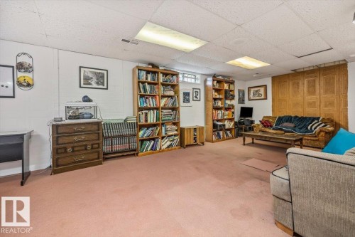 Spacious lower-level perfect for movie nights or entertaining - 9732 64 Street, Edmonton, AB - Indoor Photo Showing Other Room