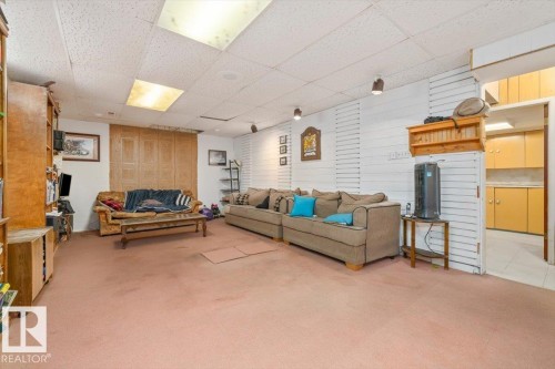 Carpeted recreation area with track lighting and drop panel ceiling - 9732 64 Street, Edmonton, AB - Indoor